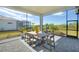 Relaxing screened patio with outdoor dining furniture at 8066 Redonda Loop, Bradenton, FL 34202