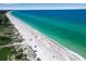 Scenic beach view with white sand and umbrellas at 821 Evergreen Way, Longboat Key, FL 34228