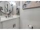 Modern bathroom with white vanity, black accents, and stylish artwork at 821 Evergreen Way, Longboat Key, FL 34228
