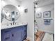 Bathroom with navy vanity, toilet, and shower at 821 Evergreen Way, Longboat Key, FL 34228