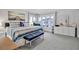 Spacious bedroom with king-size bed, blue bedding, and large windows at 821 Evergreen Way, Longboat Key, FL 34228