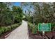 Well-manicured pathway winds through lush tropical landscaping at 821 Evergreen Way, Longboat Key, FL 34228