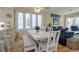 Bright dining area with white table and chairs, view into kitchen and living room at 821 Evergreen Way, Longboat Key, FL 34228