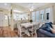 White dining table with chairs and bench seating, open to kitchen and living areas at 821 Evergreen Way, Longboat Key, FL 34228