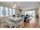 Charming dining area with white table, bench seating, and access to the living room at 821 Evergreen Way, Longboat Key, FL 34228