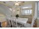 Open concept dining area with white table and chairs near kitchen and living areas at 821 Evergreen Way, Longboat Key, FL 34228