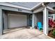 Attached garage with teal door and blue chair at 821 Evergreen Way, Longboat Key, FL 34228
