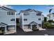 Two-story light blue townhome with attached garage at 821 Evergreen Way, Longboat Key, FL 34228