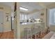 Kitchen with white cabinets, breakfast bar with stools, and window at 821 Evergreen Way, Longboat Key, FL 34228