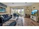 Living room with blue sofas and a large TV at 821 Evergreen Way, Longboat Key, FL 34228