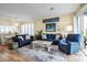 Spacious living room with blue sofas and access to kitchen at 821 Evergreen Way, Longboat Key, FL 34228