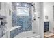 Walk-in shower with blue fish-scale tile and built-in seat at 821 Evergreen Way, Longboat Key, FL 34228
