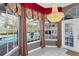 Bright breakfast nook with pool view, chandelier, and elegant window treatments at 8348 9Th Avenue Nw Ter, Bradenton, FL 34209