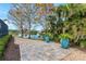 Landscaped walkway leading to a serene patio and water view at 8348 9Th Avenue Nw Ter, Bradenton, FL 34209