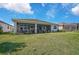 Large backyard with a screened patio and lush landscaping at 8612 Sundance Loop, Sarasota, FL 34238