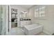 Bathroom with soaking tub, walk-in shower, and double vanity at 8612 Sundance Loop, Sarasota, FL 34238