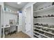 Large walk-in closet with built-in shelving and drawers at 8612 Sundance Loop, Sarasota, FL 34238