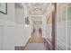 Bright and spacious entryway with wood floors and wainscoting at 8612 Sundance Loop, Sarasota, FL 34238