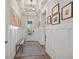 Light and airy entryway with wood floors and bench at 8612 Sundance Loop, Sarasota, FL 34238