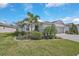 Single-story home with landscaped yard, two-car garage, and attractive curb appeal at 8612 Sundance Loop, Sarasota, FL 34238