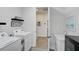 Bright laundry room with washer, dryer, and additional storage at 8612 Sundance Loop, Sarasota, FL 34238