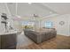 Bright living area with hardwood floors, a sectional sofa, and large windows at 8612 Sundance Loop, Sarasota, FL 34238