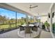 Relaxing screened patio with outdoor dining set and ceiling fans at 8612 Sundance Loop, Sarasota, FL 34238