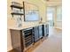 Custom wet bar with wine cooler and ample storage at 8612 Sundance Loop, Sarasota, FL 34238
