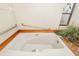 Accessible bathtub with grab bars and wooden surround at 917 S Doral Ln, Venice, FL 34293