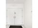 Bright entryway with white double doors and a simple black mat at 917 S Doral Ln, Venice, FL 34293
