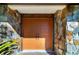 Double orange front doors with stone facade at 917 S Doral Ln, Venice, FL 34293