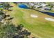 Aerial of golf course with sand traps and water at 917 S Doral Ln, Venice, FL 34293