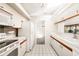 View of kitchen from dining area, white appliances at 917 S Doral Ln, Venice, FL 34293