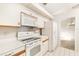Kitchen with white appliances and view to dining room at 917 S Doral Ln, Venice, FL 34293