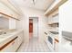 Galley kitchen with white cabinets and appliances at 917 S Doral Ln, Venice, FL 34293