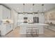 Modern white kitchen with a large island, stainless steel appliances, and white cabinets at 10024 Lake Wales Cir, Sarasota, FL 34241