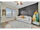 Cozy Gathering room with a comfy sofa, herringbone accent wall, and large windows at 1027 Kestrel Ct, Bradenton, FL 34208