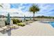 Spacious pool deck with lounge chairs and umbrellas at 10510 Boardwalk Loop # 602, Bradenton, FL 34202