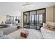 Open living space with a daybed, sofa, and balcony access at 11 Sunset Dr # 406, Sarasota, FL 34236