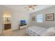 Bright bedroom with ensuite bathroom and tv at 12607 Wheatgrass Ct, Parrish, FL 34219