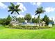 Cross Creek community entrance with palm trees and signage at 12607 Wheatgrass Ct, Parrish, FL 34219