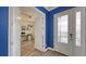 Spacious entryway with blue accent wall and hardwood floors at 12607 Wheatgrass Ct, Parrish, FL 34219