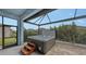 Relaxing hot tub with screened enclosure and wooden steps at 12607 Wheatgrass Ct, Parrish, FL 34219