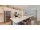 Modern kitchen with white cabinets, stainless steel appliances and an island with seating at 12607 Wheatgrass Ct, Parrish, FL 34219