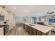 Open concept kitchen with island, stainless steel appliances, and views into the living room at 12607 Wheatgrass Ct, Parrish, FL 34219