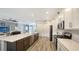 Open concept kitchen with large island, stainless steel appliances and dark brown cabinets at 12607 Wheatgrass Ct, Parrish, FL 34219