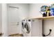 Laundry room with washer, dryer, and ample storage at 12607 Wheatgrass Ct, Parrish, FL 34219