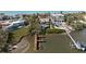 Aerial view of a waterfront house with a dock in a coastal setting at 140 N Casey Key Rd, Osprey, FL 34229
