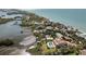 Waterfront property featuring a private pool and dock, with stunning ocean views and lush greenery at 140 N Casey Key Rd, Osprey, FL 34229