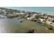 An aerial view showcases stunning waterfront homes with private docks and boat access at 140 N Casey Key Rd, Osprey, FL 34229